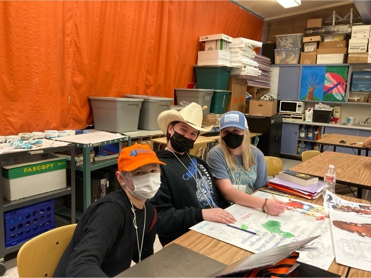 Students and staff with hats
